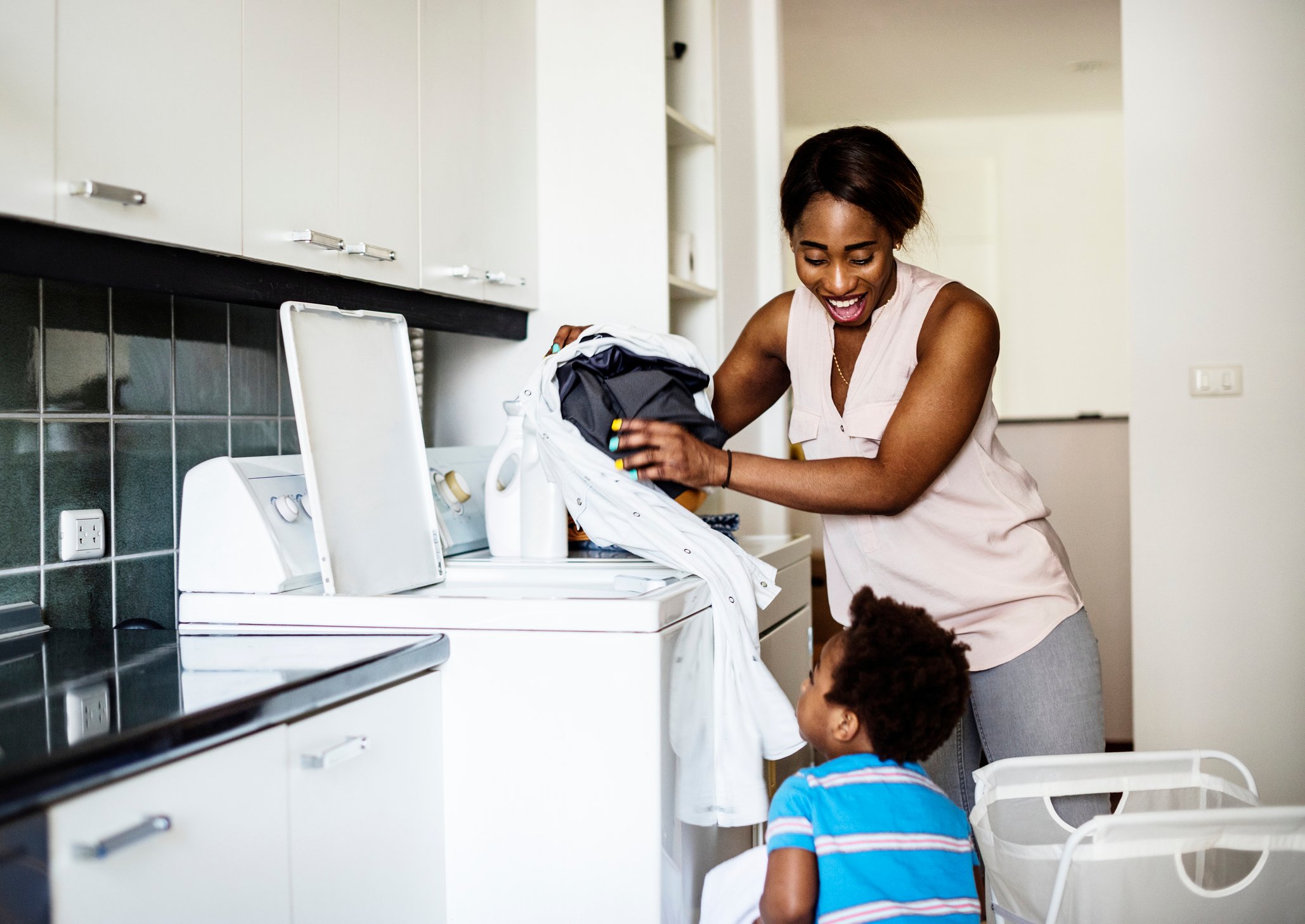 Mom helping son do laundry