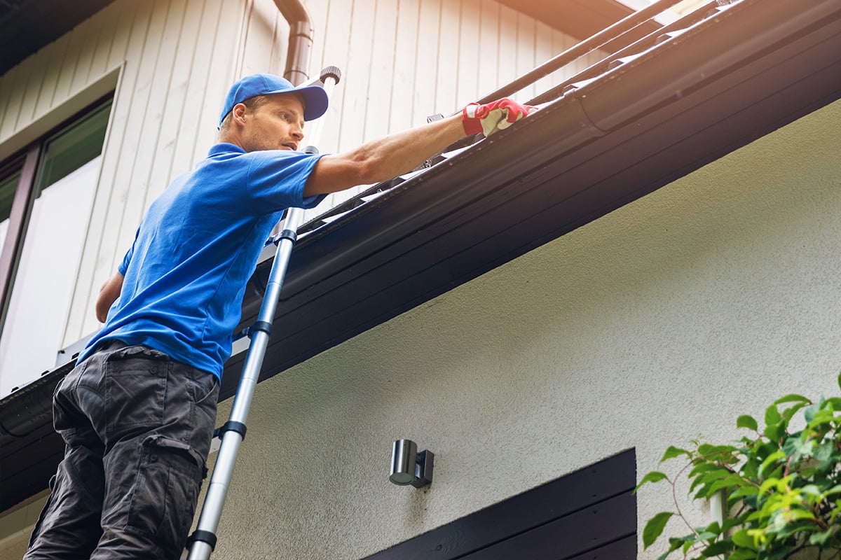 man-cleaning-gutters